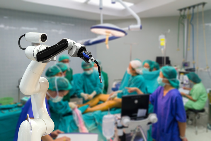 Robotic arm assisting in a sterile operating room during surgery.