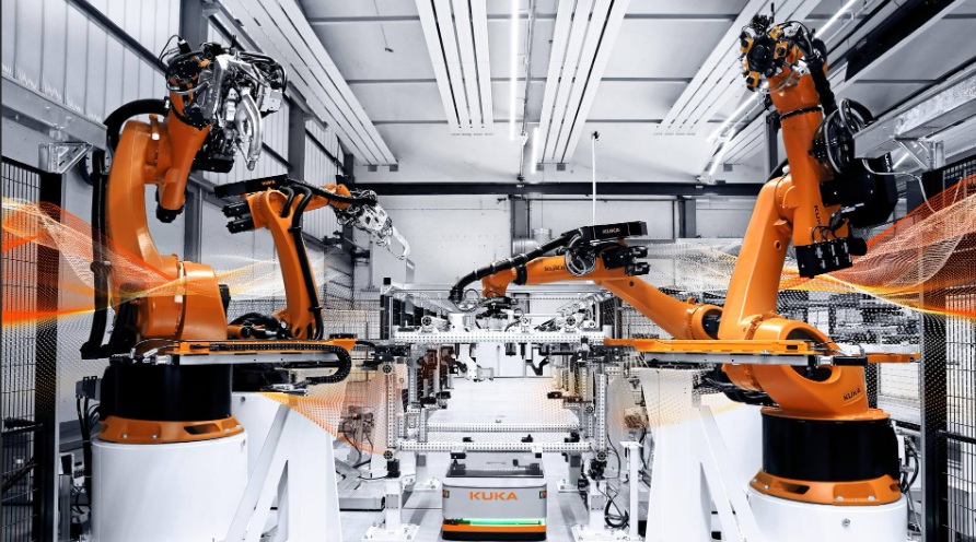 Robotic arms working in a high-tech manufacturing facility.